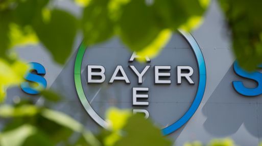 (FILES) This file photo taken on July 24, 2013 shows a logo of German pharmaceuticals and chemicals giant Bayer on an overpass at its Berlin headquarters. Shares in Bayer slid by seven percent at the start of trade on May 19, 2016 after the company said it was in merger talks with US agricultural firm Monsanto. / AFP / JOHN MACDOUGALL